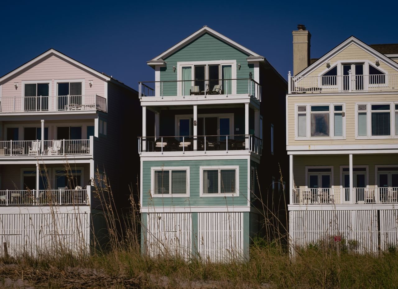 Crafting Captivating Headlines: Your awesome post title goes here Sunny day view of colorful coastal homes with wooden siding and balconies, perfect for summer living.